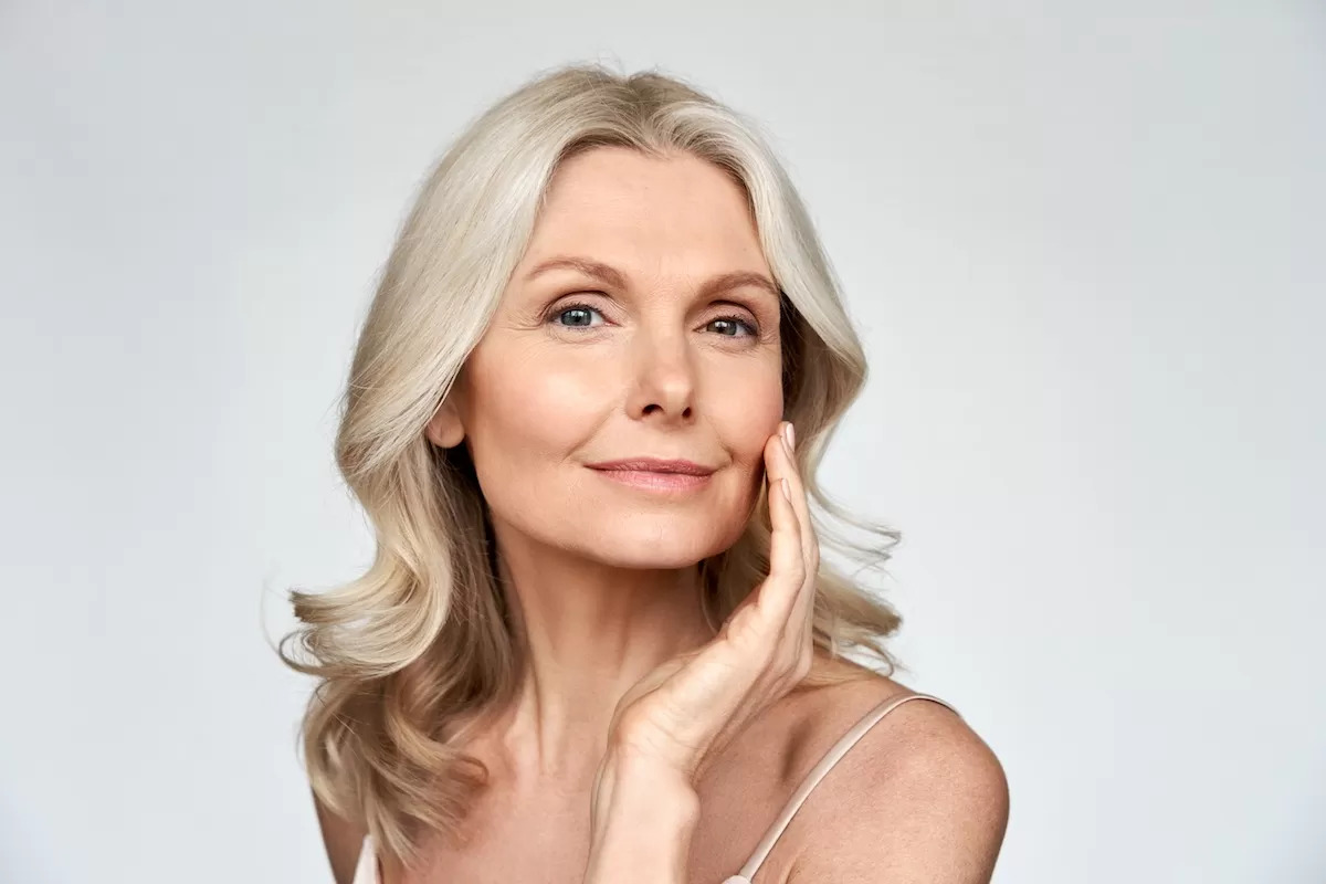 Beautiful older woman posing with hand under her chin